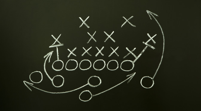 Game strategy drawn with white chalk on a blackboard.